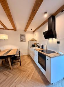 a kitchen with a table and a dining room at Blisko in Kuźnica