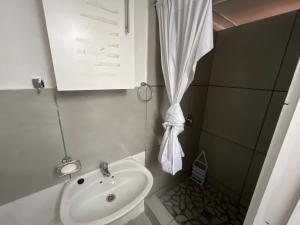 a small bathroom with a sink and a toilet at The Pearl at Strand in Strand