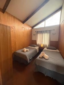 a room with two beds with towels on them at Mana Make Make in Hanga Roa