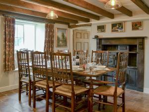 a dining room with a wooden table and chairs at Westfield Farm Uk33124 in Kirby Misperton