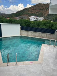 a swimming pool with blue water in a building at Mirşah Suit in Bezkesen