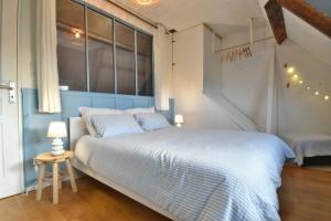 Postel nebo postele na pokoji v ubytování Le Cocon Bleu
