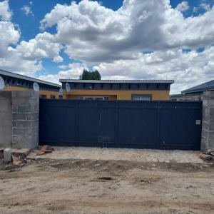 a blue fence in front of a house at The Rest in Maseru