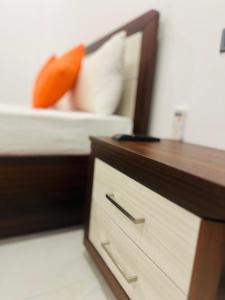 a wooden dresser with a mirror and a drawer at Shrek Villa in Balapitiya
