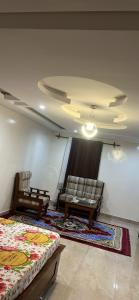 a room with two chairs and a bed and a couch at Keur Mame Coumba in Saint-Louis