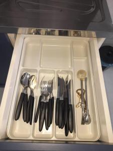 a white tray with utensils on a table at Modern cozy, for 5 with air in Guaíra