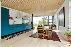a kitchen with blue cabinets and a table with chairs at Sea View, Sunrise And 200 Meters To The Water in Kalundborg +28 photos