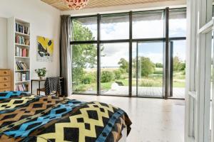 a bedroom with a bed and a large window at Sea View, Sunrise And 200 Meters To The Water in Kalundborg