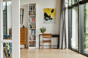 a room with a desk and a book shelf with books at Sea View, Sunrise And 200 Meters To The Water in Kalundborg