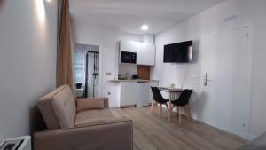 a living room with a couch and a table at Apartamentos Recunchos in Ourense