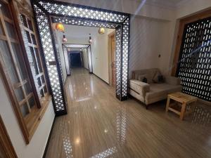 a hallway with a living room with a couch and lights at Nawab's Hotel Balakot in Bālākot