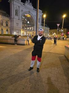 a man dressed as a santa claus standing in front of a building at Maison in Vétroz