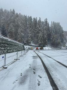 a snow covered road with cars driving on it at Maison in Vétroz