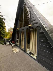 a screened in porch of a house with windows at Котедж Синевир in Synevyr