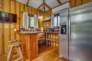 una cocina con refrigerador de acero inoxidable y encimera en Kmar Villas, en Placencia Village