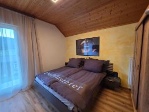 a bedroom with a large bed in a room at Ferienhaus DaPfusterer in Bad Mitterndorf