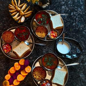 a group of bowls of food on a table at Chaloba Hills Agro Resort in Ajra +70 photos