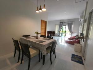 a dining room table and chairs in a room at At My Home in Ban Pha Saeng Lang