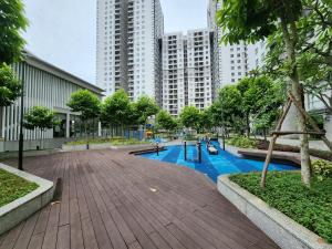 a playground in the middle of a city with tall buildings at Elite Apartment - Resort Pool & Gym by Center HCMC in Ho Chi Minh City