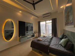 a bedroom with a large bed and a large window at Kremlin Luxury Studios in Ghaziabad +10 photos