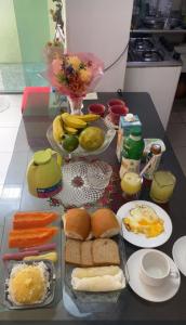 a table topped with different types of food at hospedaCOP30Roma in Belém
