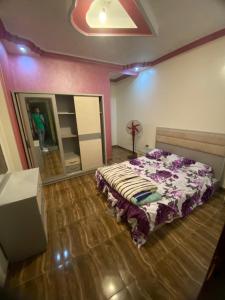 a bedroom with a bed and a person in a room at شقة من اميز الأماكن بالزقازيق in Kafr az Zand