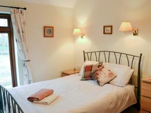 a bed with a man sticking his head in pillows at Hog Pits - 18961 in Tytherton Lucas