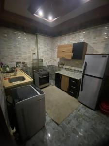 a kitchen with a white refrigerator and a sink at شقة من اميز الأماكن بالزقازيق in Kafr az Zand
