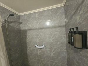 a shower in a bathroom with a shower head at Departamento Dichato hasta 7 personas frente a la playa in Dichato +34 photos