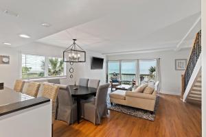 a dining room and living room with a table and chairs at SG10C: 10C Seagrove Villa in Isle of Palms