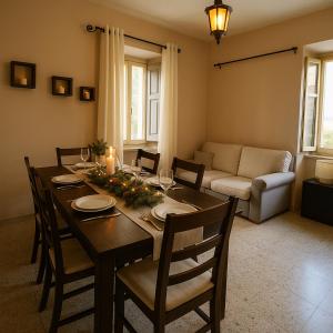 a dining room with a table with chairs and a couch at CASA VACANZA Dimora del tempo in Fara San Martino