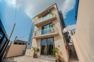 a tall building with plants in front of it at GreyCity Apartments in Accra