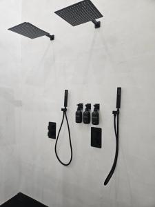 a wall with four bathroom fixtures on a wall at La suite Cherbourgeoise in Cherbourg en Cotentin +7 photos