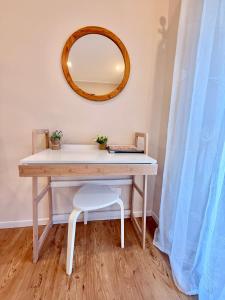 a dressing table with a mirror and a chair at Casa Kiara by KALMA in Domodossola +21 photos