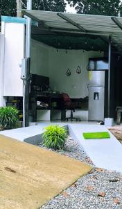 a patio with a grill and a table with plants at Sloth Glamping & Villas Fortuna in San Francisco