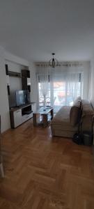 a living room with a bed and a table at Apartman Ciric in Vrnjci