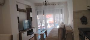 a living room with a couch and a television at Apartman Ciric in Vrnjci
