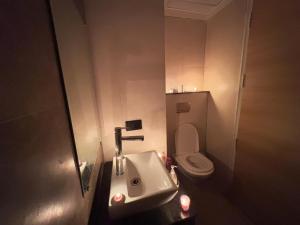 a bathroom with a sink and a toilet at Kremlin Luxury Studios in Ghaziabad