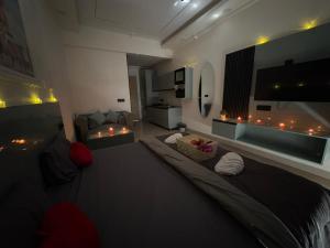 a bedroom with a large bed and a living room at Kremlin Luxury Studios in Ghaziabad