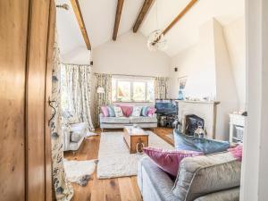 a living room with two couches and a fireplace at Tir A Mor in Nefyn