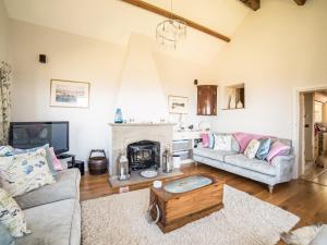 a living room with a couch and a fireplace at Tir A Mor in Nefyn