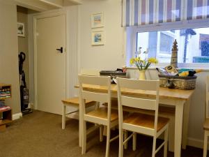 a kitchen with a table and chairs and a window at Billy Napp's Cottage in Filey