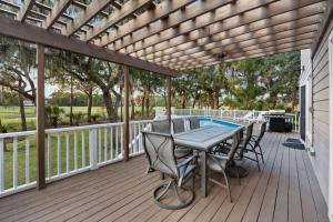 a patio with a table and chairs on a deck at MG3080: 3080 Marshgate in Seabrook Island