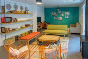 een woonkamer met een bank, een tafel en stoelen bij Moon Hill Hostel in Sintra