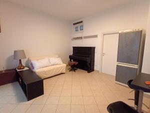 a bedroom with a piano and a bed and a chalkboard at La Casetta in Ancona +6 photos