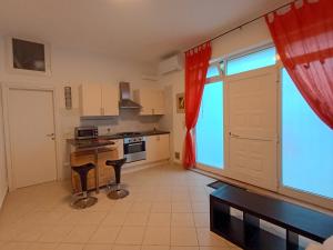 a large kitchen with a large window in a room at La Casetta in Ancona