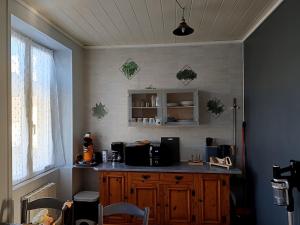 a kitchen with a counter and a window at Soso et Pat in Fourchambault