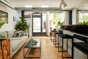 a living room with a couch and a table at Loods - RDC G in Paris