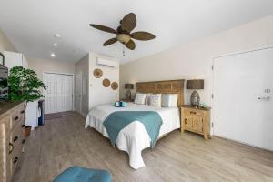 a bedroom with a bed and a ceiling fan at The One Love at Cottages in Sand Bluff