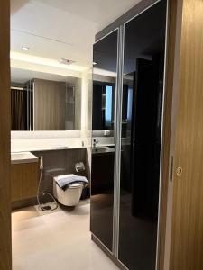 a bathroom with a sink and a toilet in it at Cozy room in Sukumvit in Bangkok